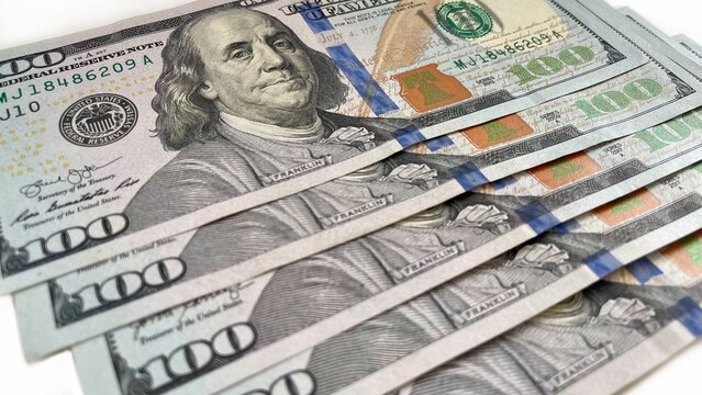 A fanned arrangement of 100 U.S. bills on a clean white background, symbolizing wealth, finance, and prosperity. Suitable for content related to banking, financial services, or economic growth.