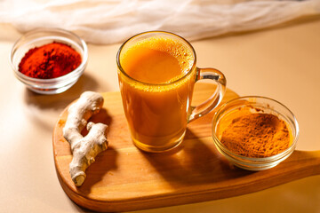 Steaming cup of herbal tea on wooden tray. Cozy atmosphere for winter evening. Concept of relax and didgital detox at home