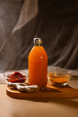 Immunity drink with turmeric powder in bottle. Homemade turmeric tea. Healthy drink with curcuma spices. Turmeric beverage for cleansing skin, normal bowel function and weightloss