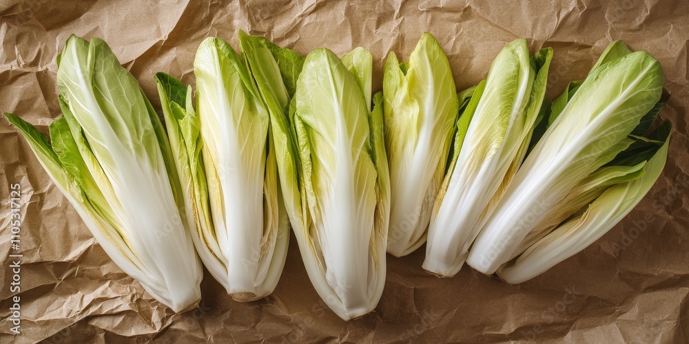 Poster fresh green endive displayed on crumpled brown craft paper from a top view perspective, highlighting