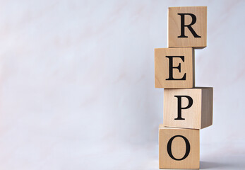 REPO - acronym on wooden cubes on a white background