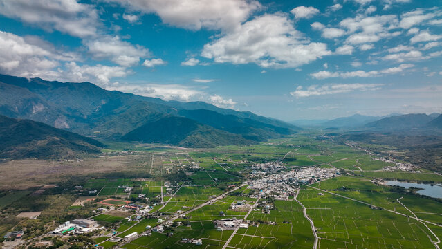 Aerial view of lush farmland and mountains in Yuli, Taiwan during a clear sunny day