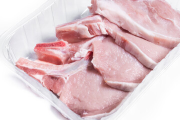 Fresh uncooked pork chops packaging isolated on white background