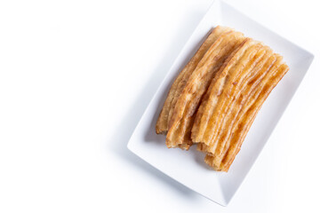 Spanish Churros. Traditional spanish food isolated on white background. Top view. Copy space
