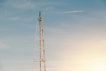 Flaring Methane Gas Fire Flare Tower in Refinery Petroleum Refinery Plant Against sunset sky background.