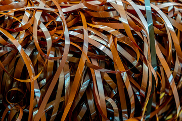 Magnetic tape unwound, magnetic audio cassette tangle, evoking nostalgia and the fragility of...
