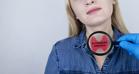 Thyroid disease and autoimmune diseases. An endocrinologist examines a patient's thyroid gland with...