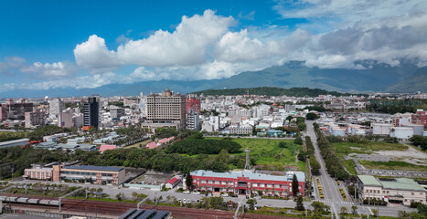 Vibrant Hualien cityscape with buildings and greenery under a blue sky