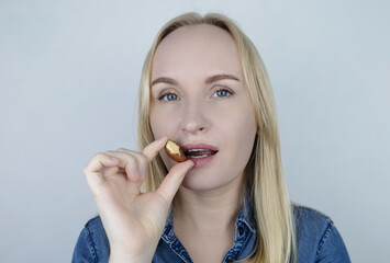 Prevention of thyroid diseases. Woman holds brazil nuts, rich in selenium, good for the thyroid...