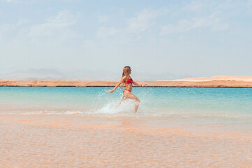 Pretty woman having fun on the beach red swimsuit leisure nature Caribbean islands