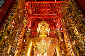 Fototapeta premium Big golden Buddha in Wat Phanan Choeng temple at Ayutthaya, Thailand