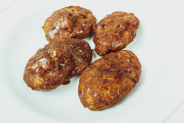 Taripang cake on a white plate on a plain white table in the dining room