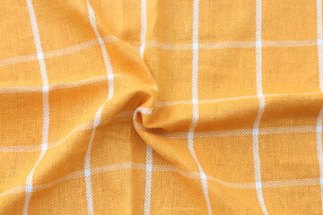 wrinkled classic yellow plaid fabric or tablecloth background