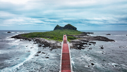 Discover Sanxiantai’s stunning coastline and iconic bridge at sunset