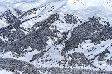 Obraz premium Beautiful landscape of the Arkhyz ski resort with mountains, snow, forest on sunny winter day. Caucasus Mountains, Russia.