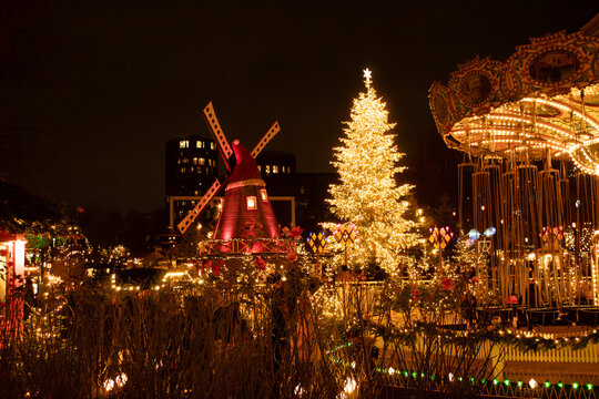 Christmas view, Tivoli gardens, decorated Christmas tree, mill, children's carousel, copenhagen, Denmark