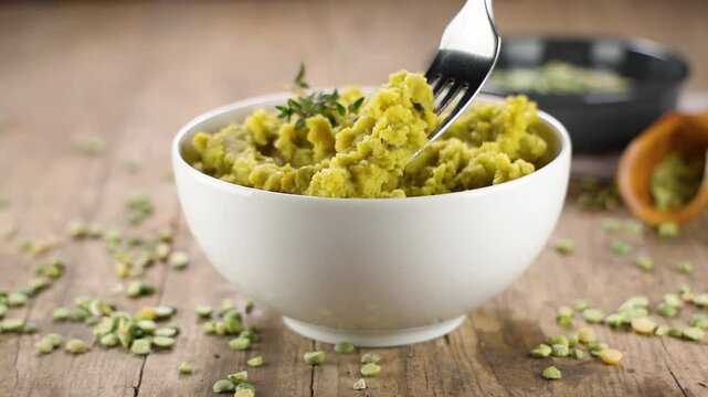 bowl of split green peas and herbs with fork- healthy eating, vegetarian food