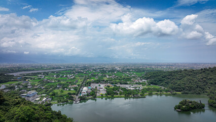 Lush Taiwan countryside features a lake and mountains under a vibrant sky