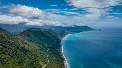 Scenic coastal view of Taiwan with lush hills and calm ocean under cloudy sky