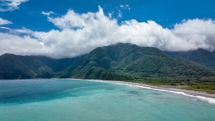 Scenic coastal view of Taiwan showcasing mountains and clear blue waters under a cloudy sky