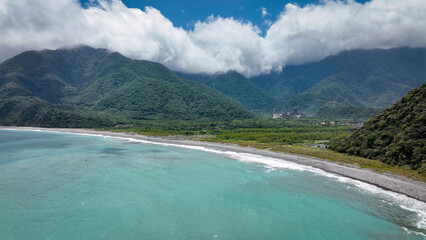 Stunning coastal landscape of Taiwan with mountains and lush greenery under a bright sky