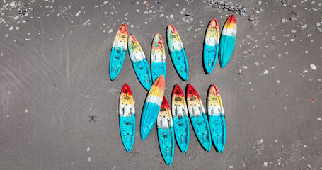 Colorful surfboards arranged on the sandy beach of Taiwan during a sunny day