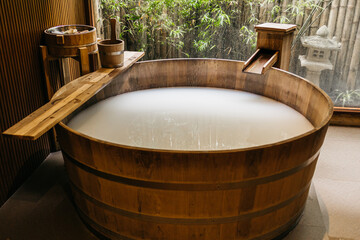 Wooden bath with milk or powdered water. Spa, relaxation and vacation concept.