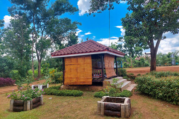 Naklejka premium The wooden gezebo in the garden in front of the mosque is cloudy