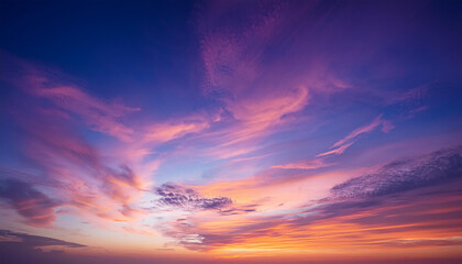 Obraz premium Dreamy sunset horizon painted in violets and pinks, soft orange and peach tones. Wispy cloud trails