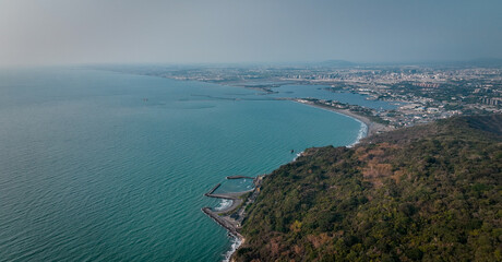 Aerial view of the coastline and cityscape of Kaohsiung Taiwan during a clear sunny day