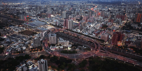 Aerial view of Kaohsiung vibrant urban landscape at twilight with busy traffic