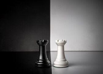 Conceptual composition with chess pieces in dramatic light, duality, good versus evil, darkness...