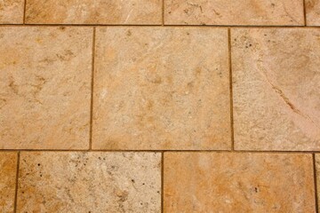 Fototapeta premium Beige Tiled Floor with Natural Stone Texture in Close-Up