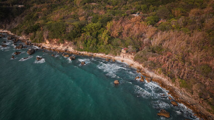 Afternoon coastal view of Taiwan rocky shoreline and lush greenery