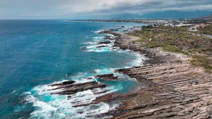 Coastal view of Taiwan with rocky shorelines and vibrant ocean during cloudy day