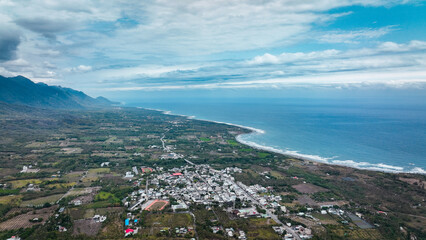 Fototapeta premium Aerial view of Taiwan coastline and rural landscape showcasing mountains and ocean