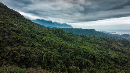 Lush green mountains and coastline under dramatic clouds in Taiwan scenic landscape