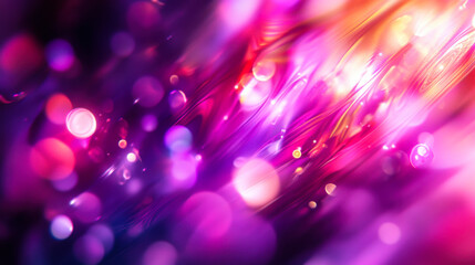 Vibrant abstract background featuring colorful light trails and bokeh effects in shades of pink, purple, and orange during twilight
