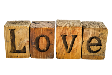 Heartwarming message "Love" displayed on a wooden cube isolated on transparent background