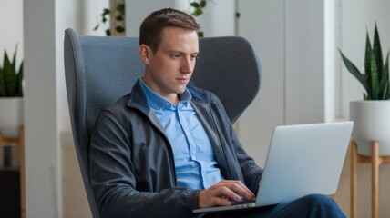 Professional Man Working on Laptop in Modern Office Workspace Sitting on a chair Office Desk Background.  team working company office work, business meeting workplace office environment man working