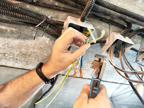 Technician working on electrical connections in a structured wiring installation at a residential property