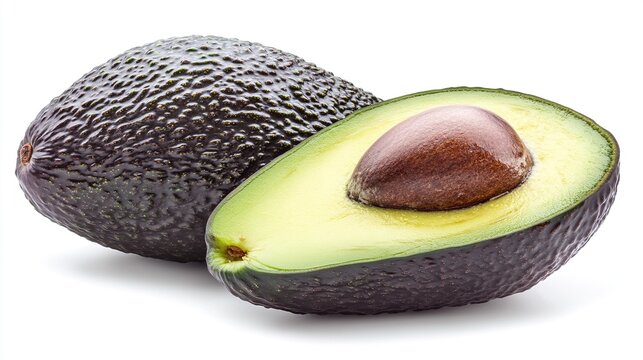 A dark, ripe avocado cut in half to show the pit on a white background.