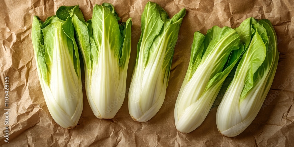 Aufkleber fresh green endive displayed on crumpled brown craft paper from a top view perspective, highlighting