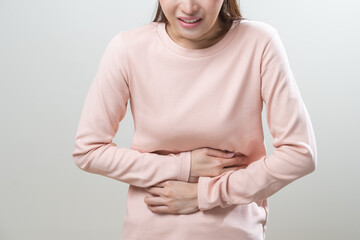 Flatulence asian young woman intolerance hand in stomach ache, suffer from food poisoning,...