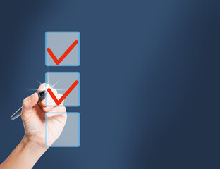 Female hand with a pen choosing several options from three check marks. 
