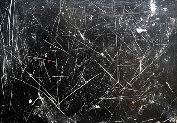 Black background with grungy white scratches and dust