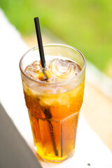 The fresh afternoon iced tea with a straw looks tempting
