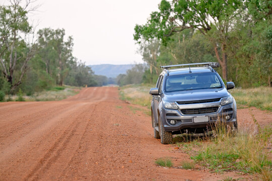 4WD car vehicle beside outback red dirt track road, Australian bush countryside, rural remote distance travel journey destination, tree forest gum eucalyptus, escape change leave