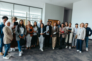 Diverse professional team posing happily at a seminar event indoors