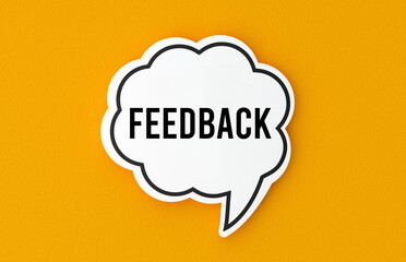 Feedback concept written in a speech bubble. Yellow background, illustration.
